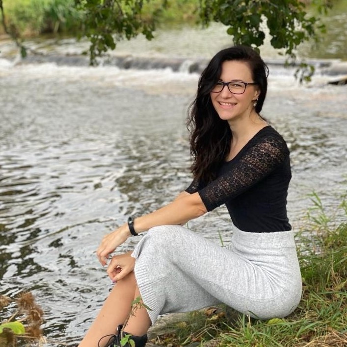 Sina sitzt an einem See